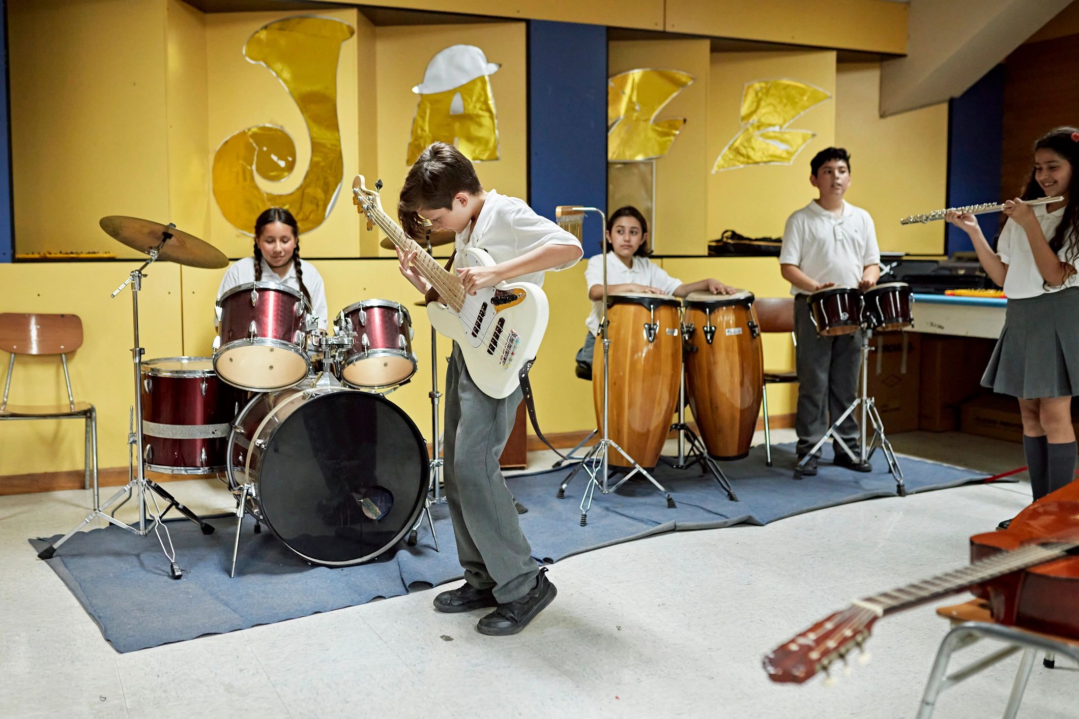Student musicians playing together in rehearsal